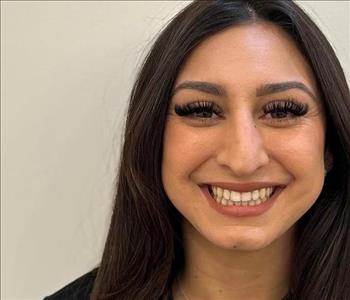 female employee with dark brown slick back hair 