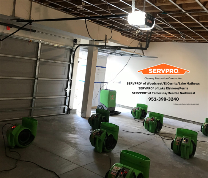 air movers and dehumidifier in a garage, airing out the demoed celling. 