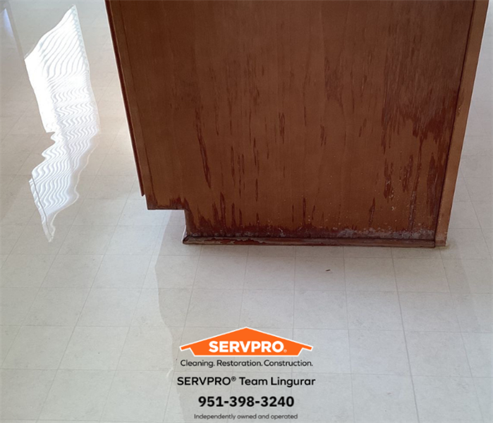 Flooded kitchen with standing water. Kitchen Island and cabinets are damaged. 