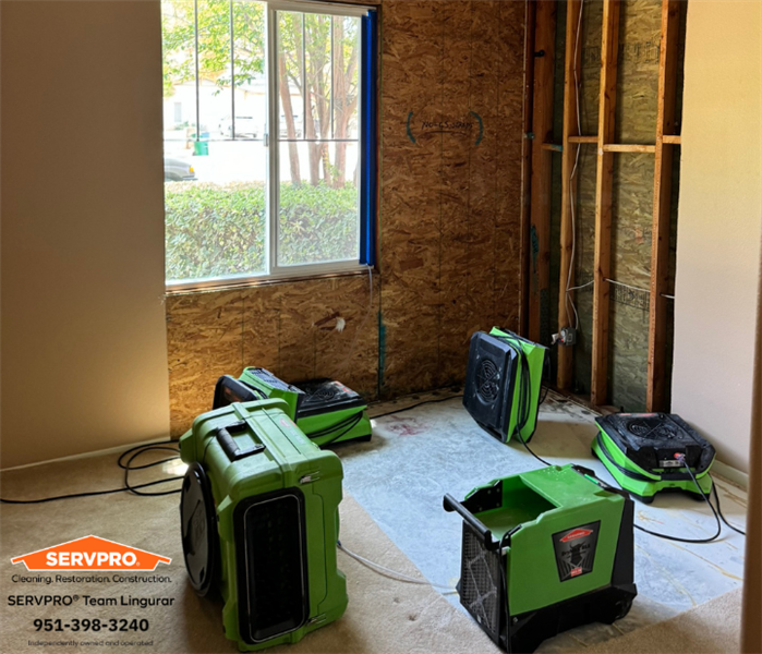 Air movers, dehumidifiers doing their job drying the walls and celling in this Lake Elsinore bed room.